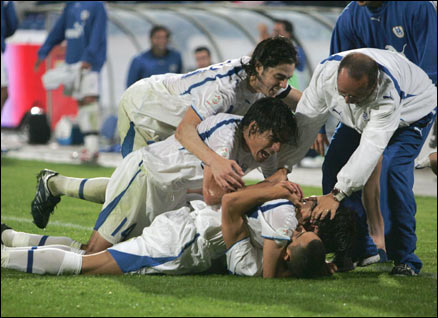 Israeli players jump on teammate Omer Golan after scoring their winning goal