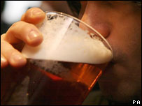 A person drinking a pint of beer