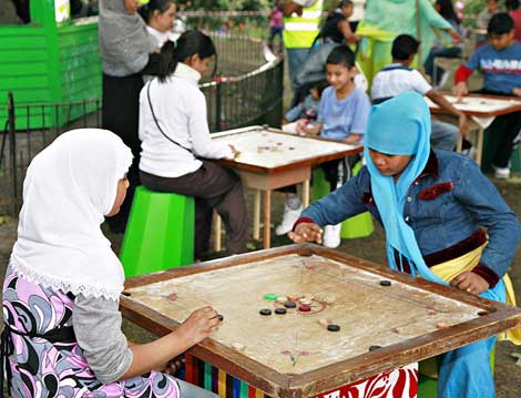 Girls playing carrom