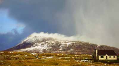 Snow is blasted off Eaval, North Uist