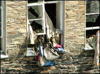 August 2004 - Belongings hang from broken windows.