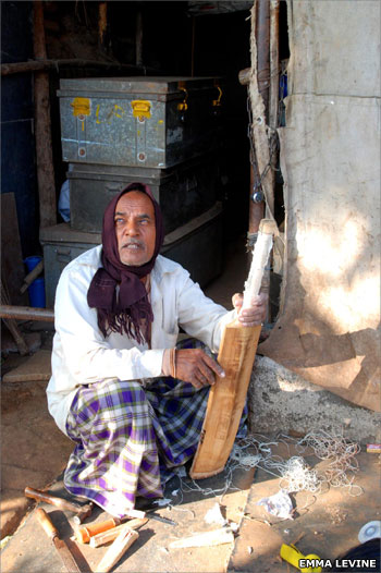 Man repairing cricket bat