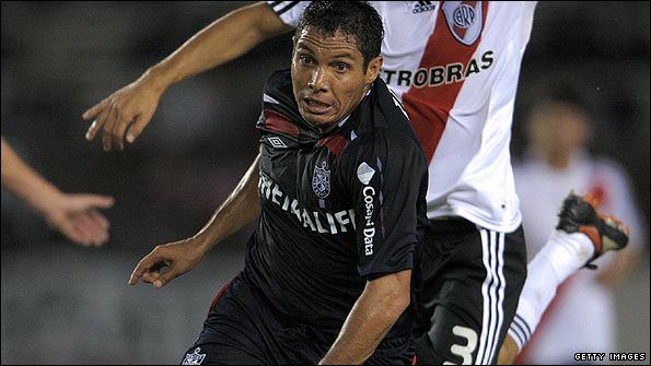 Peru's San Martin's Martin Arzuaga shakes off a Boca Juniors defender