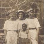 L to R: Len Thacker, Jack Leathersich and Algy Hobber with their washer boy in Freetown.