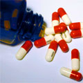 Pill capsules spilling out of a bottle