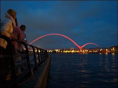 Infinity Bridge is illuminated for the first time.