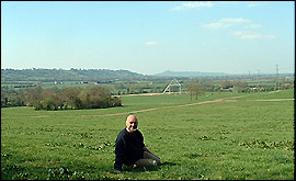 Michael Eavis with the Pyramid stage and Glastonbury Tor in the background