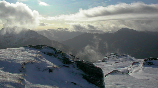 A view of snowy mountains from the top