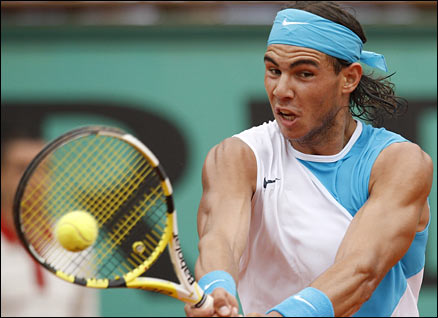 Defending champion Rafael Nadal backhands during the French Open semi-final match