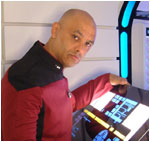 Tony Alleyne in Star Trek uniform practising his beam up technique at the Transporter