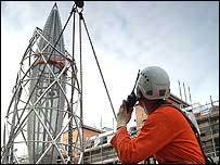 A workman admires the spire