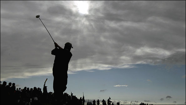 A silhouetted Darren Clarke hits a shot off the 12th tee
