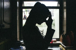 A silhouette of an unhappy-looking woman