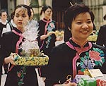 Women carrying gifts during the festival of Wesak in Manchester