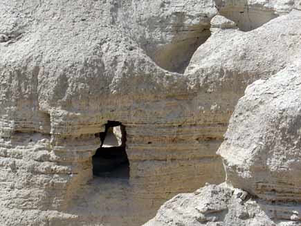 Cave mouth in mountainous, curved rocky slopes