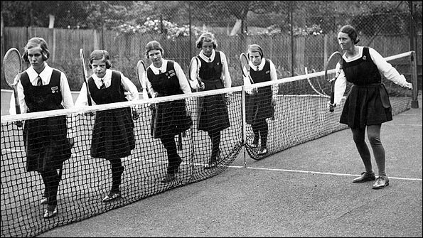 Sports mistress Betty Green giving some tennis training to young school girls at Northwood College, Middlesex in June 1934