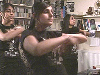 Three girls dancing arms outstretched