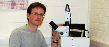 Dr Andrew Wilson at his microscope