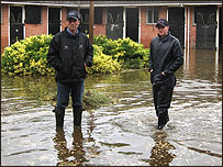 Harry Dunlop (left) in flooded yard