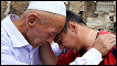 Uzbek men in Kyrgyzstan embrace among ruins