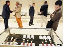Potential buyers look at the wine