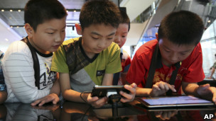 Kids looking at smartphones and tablet computers in Seoul, South Korea