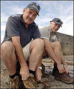 Two of the walkers checking their boots