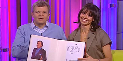 Adrian and Christine holding celebrity doodle book
