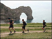 The race Runners pasing Durdle Door