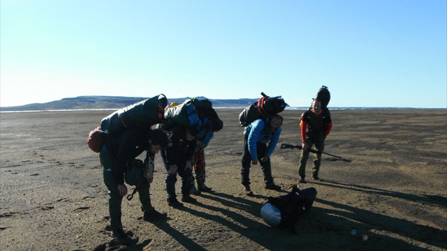 Carrying all the heavy equipment to Isachsen