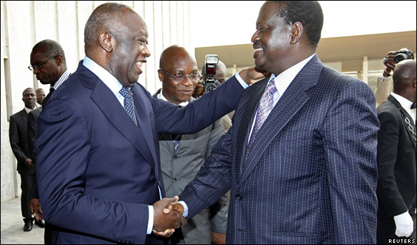 Laurent Gbagbo (left) welcomes Raila Odinga at the airport