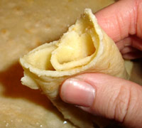 A pancake rolled up, ready to eat