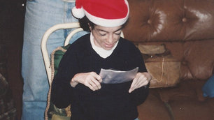 A very young Liz reading a Christmas card