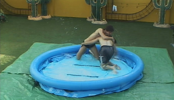 Two men wrestling in a paddling pool