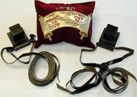 Pair of tefillin with a cushion depicting a Torah scroll