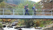 Crossing over the metal footbridge across the River Rhondda