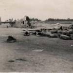 Hudson crashes into petrol dump in the act of taking off on a detachment prior to El Alemein. Photographs of the crash and the burial of the victims. Remains of crashed Hudson at El Khanka dump of petrol tins can be seen in foreground