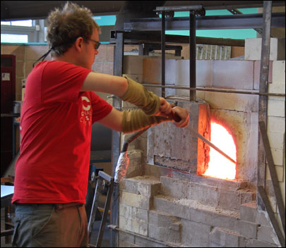 Colin puts the piece into the furnace