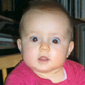 Zoe in her high-chair, the same high-chair Cormac used as a baby