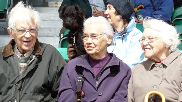 Onlookers enjoy the sunshine at the main ring on Thursday afternoon.