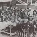 VE party in Massey Road, Gloucester, May 1945 - Josephine is on far left of picture in blazer, her brother is the glum-looking small boy in front row (he had toothache that day) and their mother is making the V-for Victory sign - wrong way round!