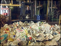 Recyclable waste being gathered up by machine