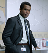 Ric (Hugh Quarshie) struggles with his work