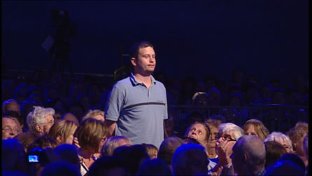 A man stand in the crowd.