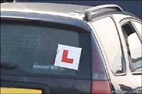 An L-plate on a car, showing the driver is learning to drive.