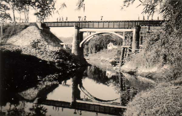 Crossing on foot bridge weakened by Japanese bombing