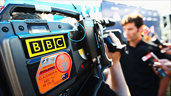Red Bull driver Mark Webber is interviewed by television crews