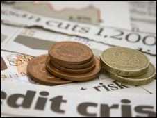money and newspaper cuttings. debt, credit, recession, coins