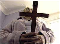 Judy holding a crucifix