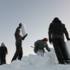 Volunteers building the ice stage designed by Portuguese architect Helder Neves.